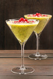 Fresh healthy kiwi drink with pomegranate on wooden background