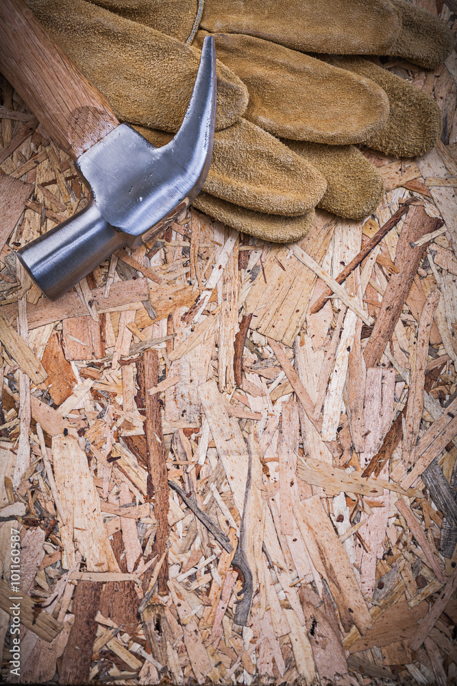 Claw hammer pair of safety gloves on OSB Stock Photo | Adobe Stock