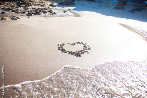 heart in sand at the beach, confession of love, summer, sea and sun photo