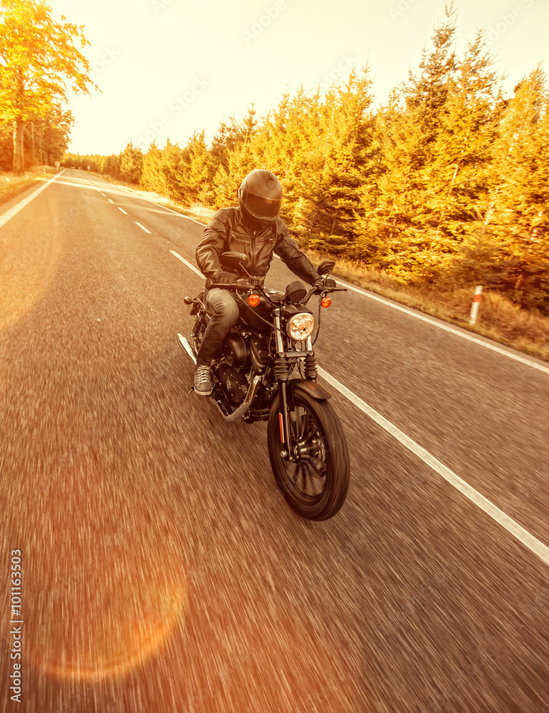 Fototapeta premium Man seat on the motorcycle on the forest road.