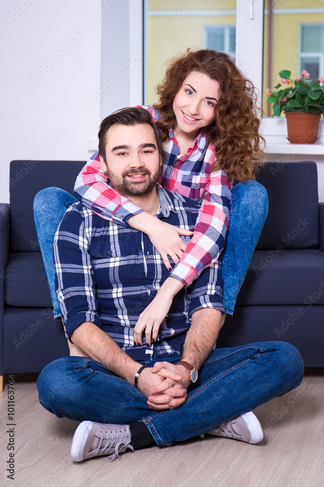 portrait of beautiful couple sitting on sofa portrait of beautiful couple sitting on sofa