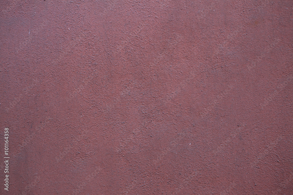 Fototapeta premium Burgundy red painted stucco wall. Background texture