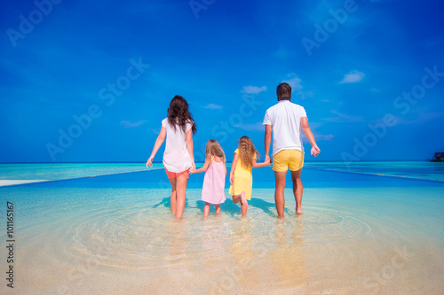 Happy family on beach vacation in Maldives 