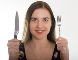 close-up slim girl in a bathing suit, a girl holding a knife and fork. concept hungry girl