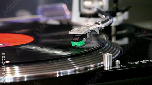 Close up of a record player playing vinyl. Retro Vinyl Turntable Stylus  photo