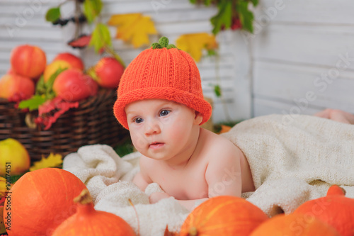 baby in the basket with pumpkins. autumn photo