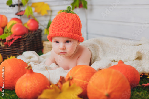 baby in the basket with pumpkins. autumn photo