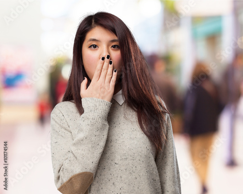cool chinese-woman covering-mouth