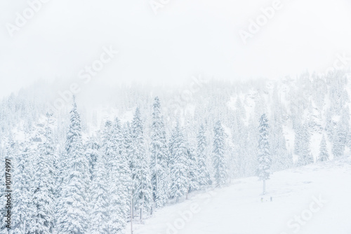 scenic view of small people walking in snow mountain. © checubus