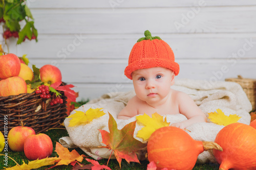 baby in the basket with pumpkins. autumn photo