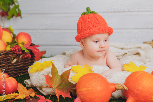 baby in the basket with pumpkins. autumn