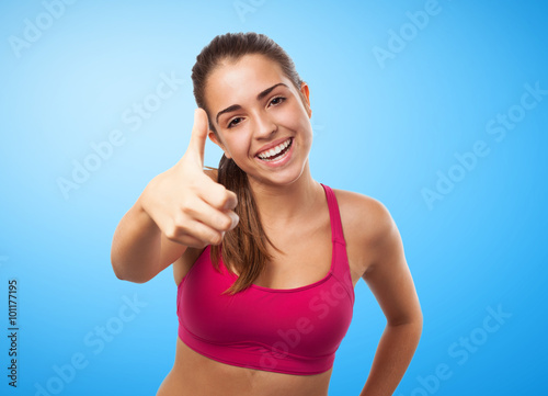 portrait of pretty sporty girl doing a positive gesture