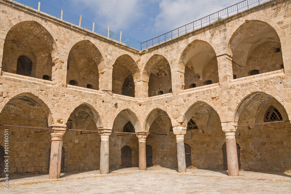 Arched gallery of Khan al-Umdan viewed from paved courtyard. Old city of Acre, Israel.
