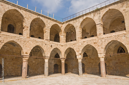 Arched gallery of Khan al-Umdan viewed from paved courtyard. Old city of Acre, Israel. 