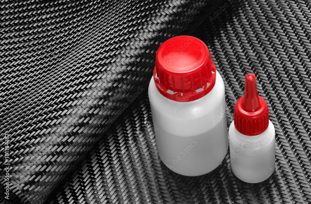 Carbon Fiber Cloth Fabric, epoxy resin and hardener. Stock Photo