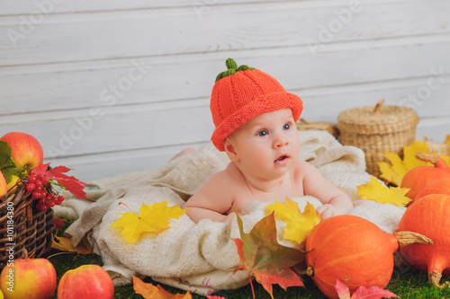 baby in the basket with pumpkins. autumn photo