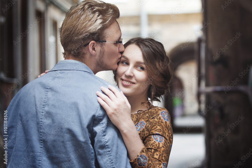 Young couple in love outdoor. Man hugs woman. The girl looks over the shoulder of a partner Young couple in love outdoor. Man hugs woman. The girl looks over the shoulder of a partner