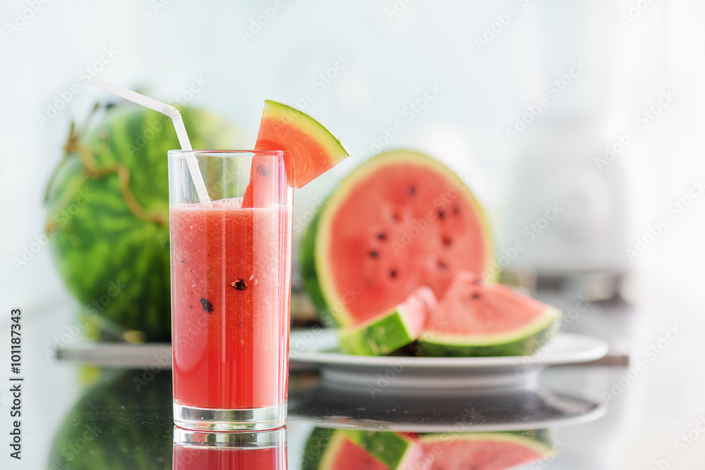 A glass of watermelon juice on kitchen table A glass of watermelon juice on kitchen table