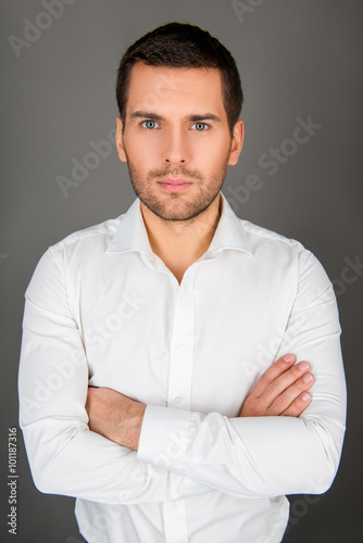 Serious young man with cross hands © deagreez
