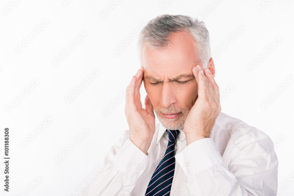 Old businessman in shirt and tie suffering from migraine Old businessman in shirt and tie suffering from migraine