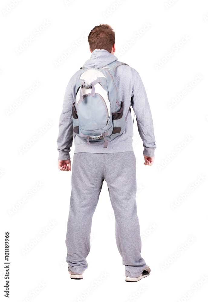 Fototapeta premium Back view of man with backpack looking up.