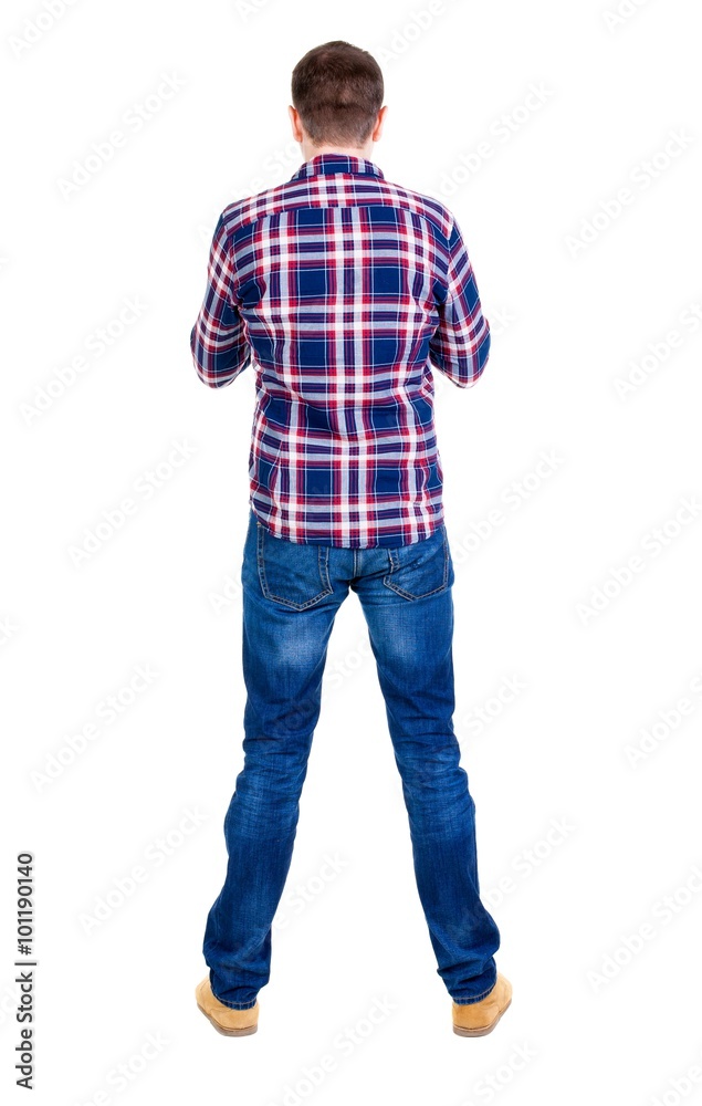 Back view of handsome man in checkered shirt looking up. Back view of handsome man in checkered shirt looking up.