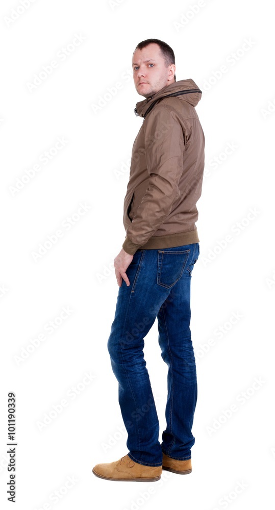 Back view of handsome man in brown windcheater looking up. Back view of handsome man in brown windcheater looking up.