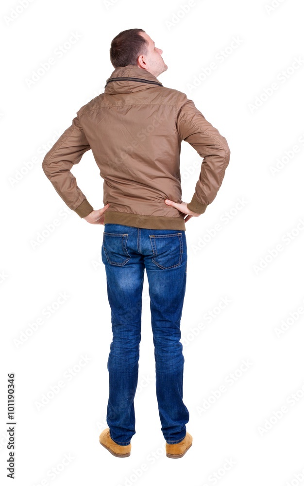 Back view of handsome man in brown windcheater looking up. Back view of handsome man in brown windcheater looking up.