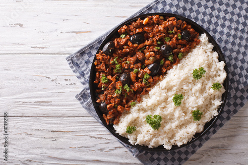 Picadillo a la habanera with rice on the table. Horizontal top view 
 photo
