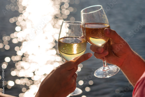 Happy couple drinks champagne on a yacht