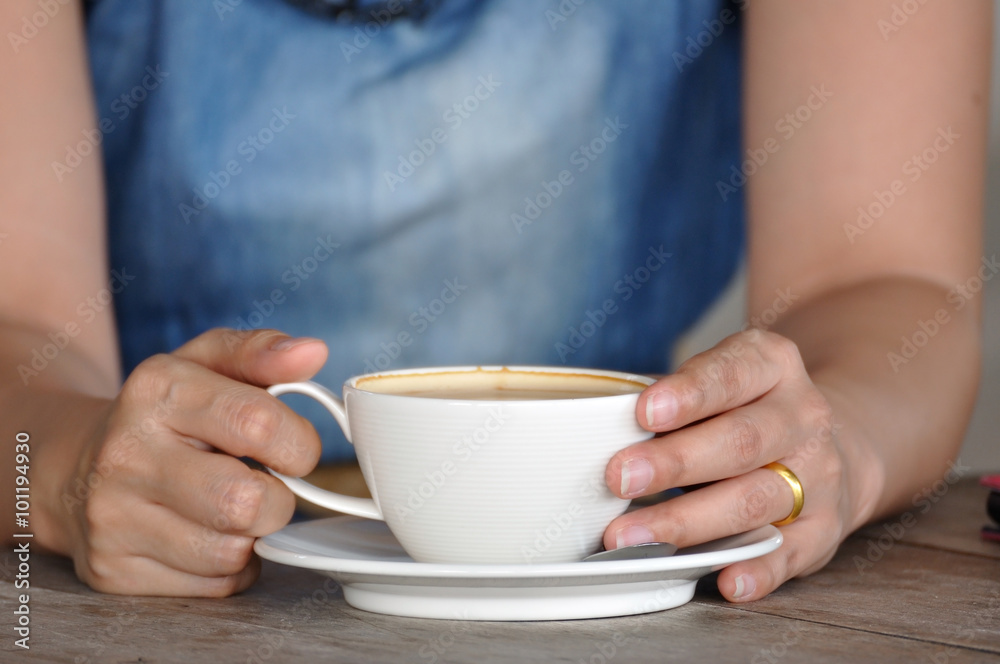 Asian woman relaxing with smartphone and coffee. Asian woman relaxing with smartphone and coffee.