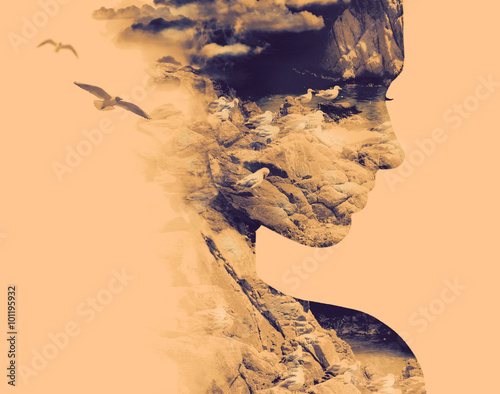 Double exposure portrait of young woman and nesting birds on the coast.