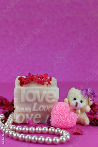 Small teddy bear with Love box.  Pink Background