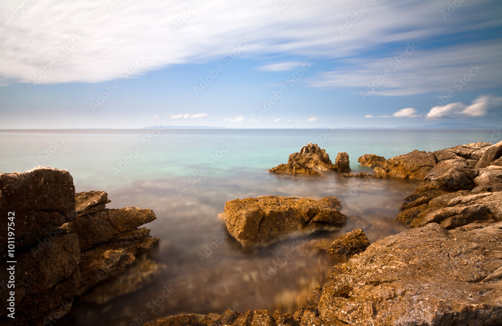 Looking over the ocean at the rocky Croatian coast, long exposure. Looking over the ocean at the rocky Croatian coast, long exposure.
