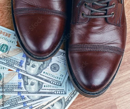 Dollars under a pair of Shoes. Business and Money or the cost of a Date.