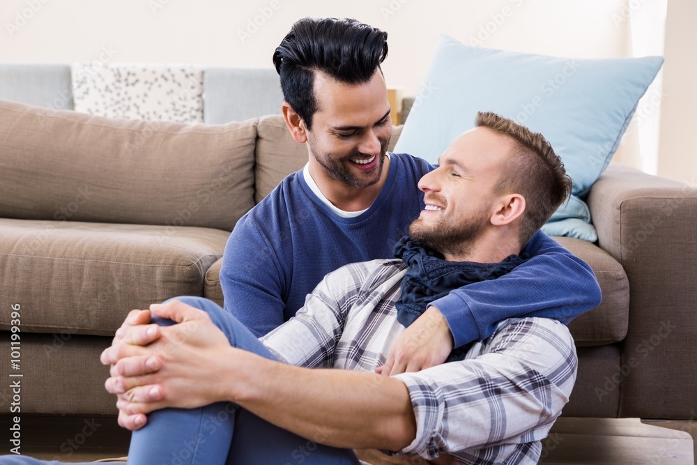 Gay couple hugging on the couch Gay couple hugging on the couch