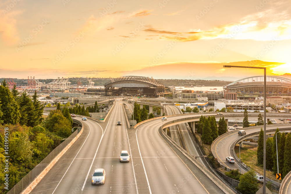scene of Seattle skylines and Interstate freeways in the sunset.