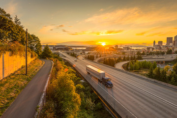scene of Seattle skylines and Interstate freeways in the sunset.