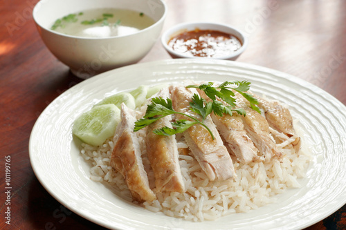 Steamed chicken with rice, soup, and spicy sauce