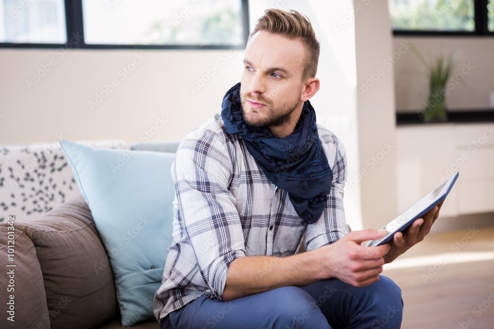 Handsome man using tablet on the couch Handsome man using tablet on the couch