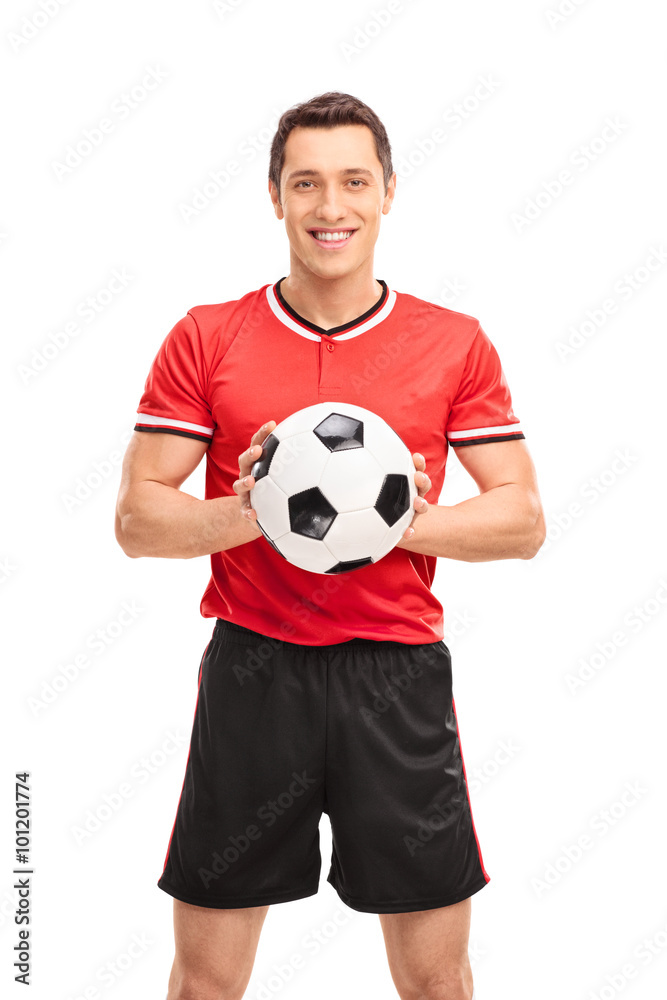 Young football player holding a ball