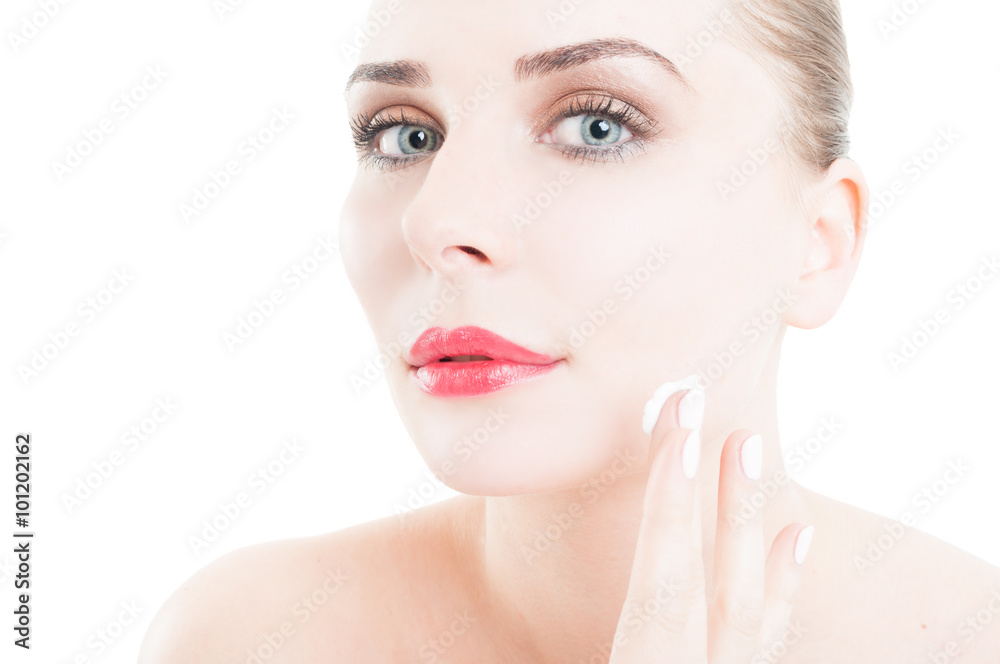 Woman applying face cream on skin care concept