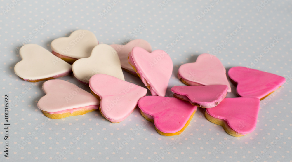 Obraz premium Pink cookies, heart shape, blue background