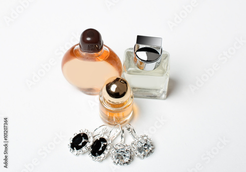 closeup of perfume bottle and jewelry set
