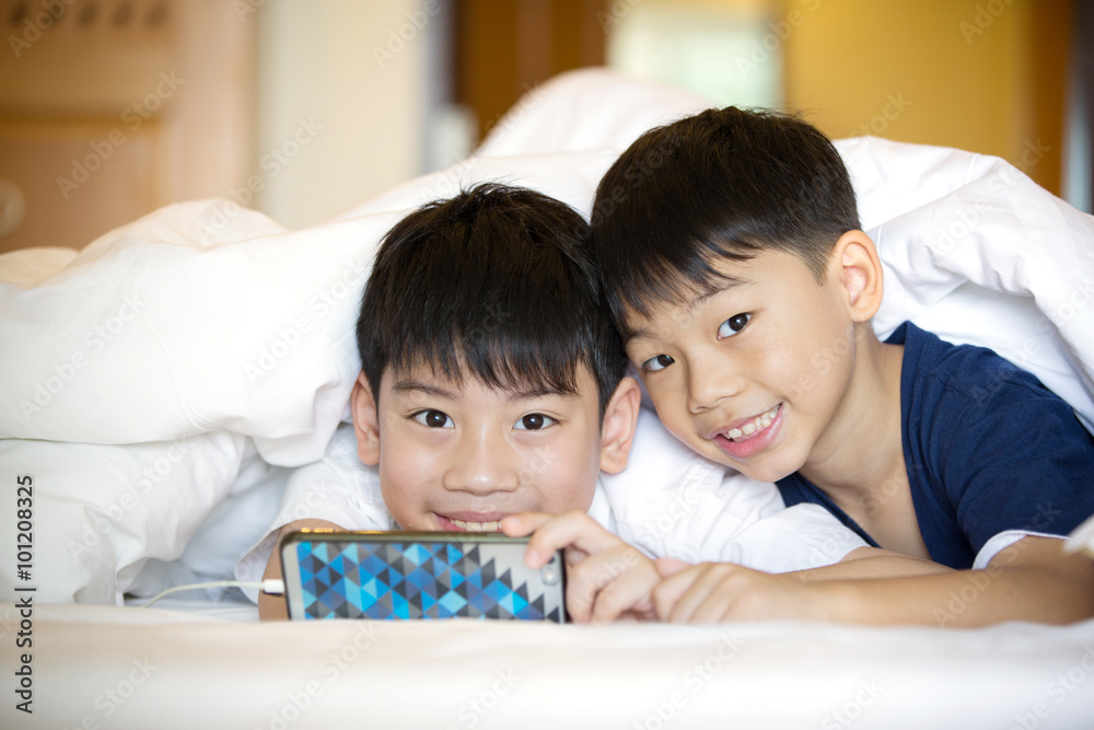 Asian Preschool boys playing on smartphone together Asian Preschool boys playing on smartphone together
