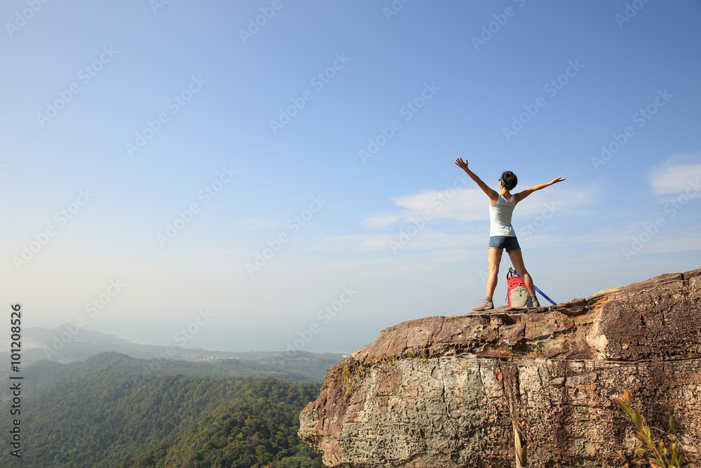 cheering woman hiker open arms at mountain peak cheering woman hiker open arms at mountain peak