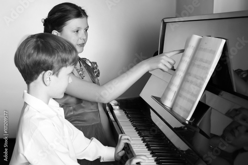 Brother And Sister Playing Piano. Piano player.