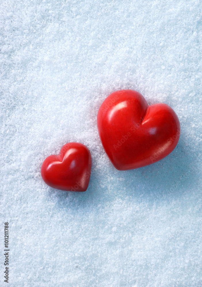 Two Red stone hearts together on white snow winter background. Love and St. Valentines Day concept. Two Red stone hearts together on white snow winter background. Love and St. Valentines Day concept.