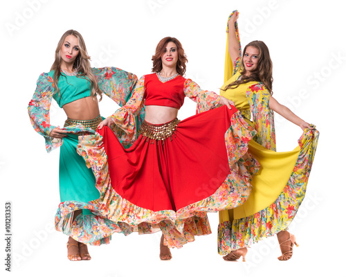 three female dancers posing, isolated on white in full length