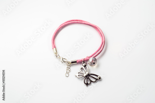 Close-up of handmade bracelet made with pink leather on white background
